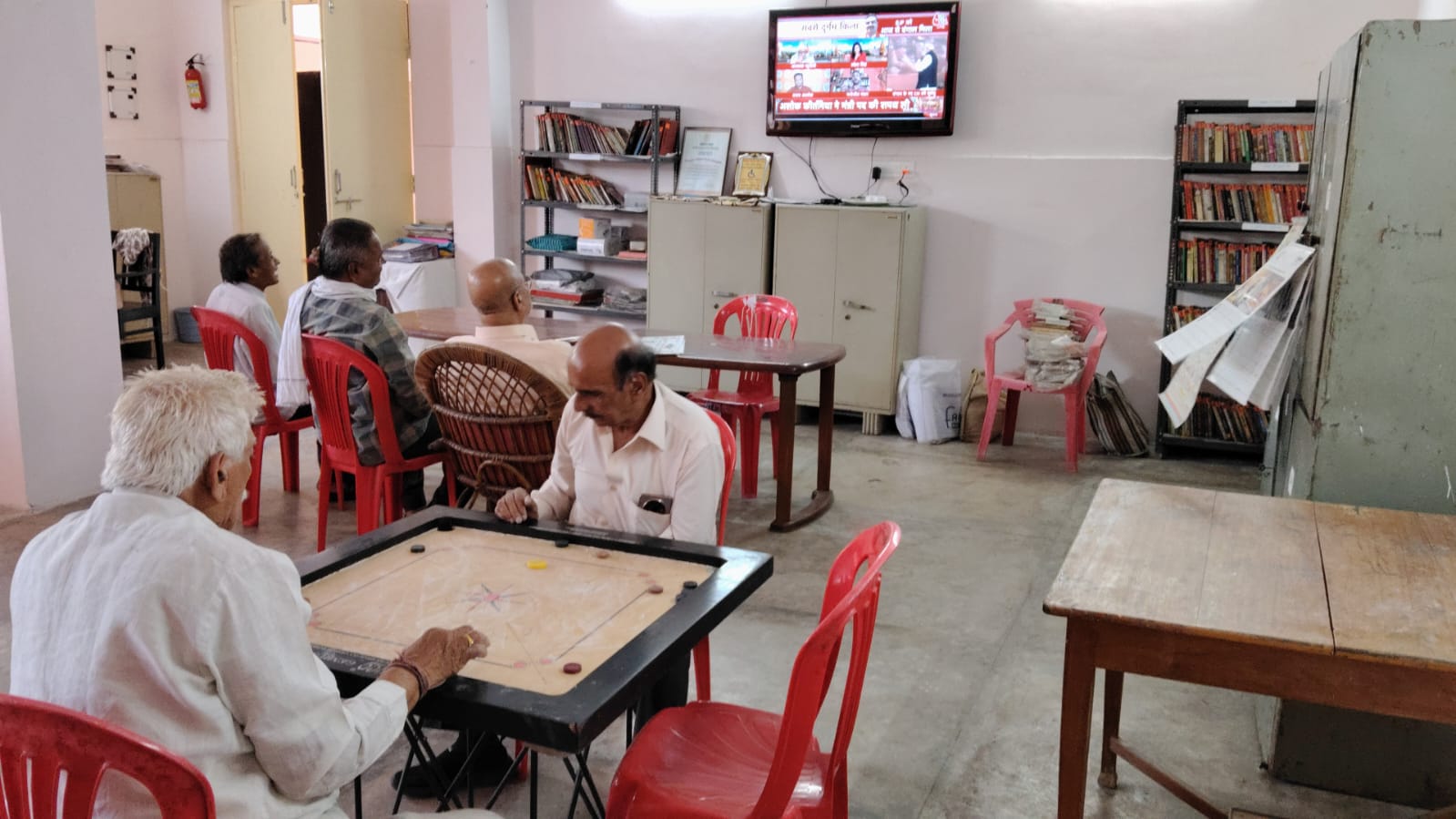 सियान गुड़ी में टीवी के सामने बैठकर राजनीतिक बहस के साथ कैरम खेलने के मजे भी ले रहे वरिष्ठ जन 